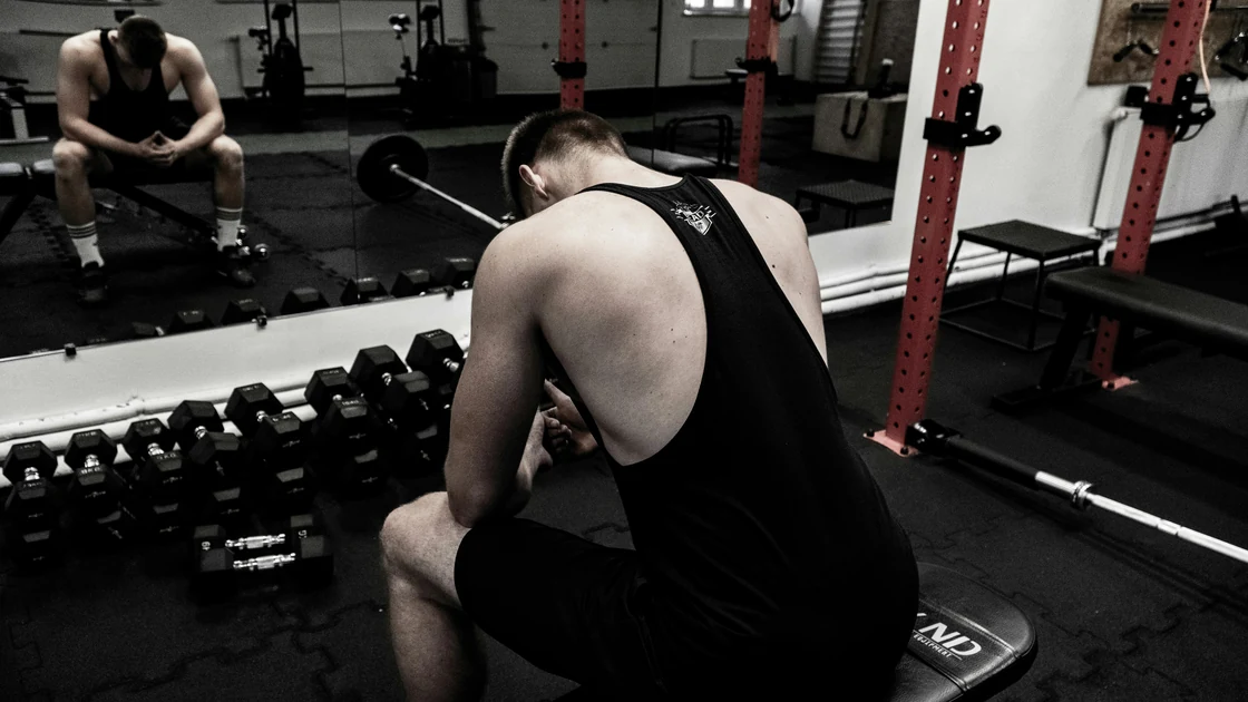 Man sitting down looking frustrated 
