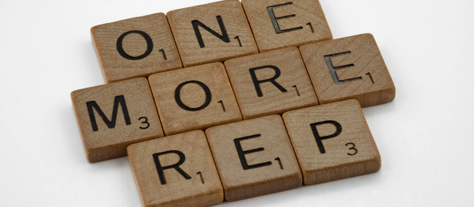 Scrabble tiles spelling out one more rep