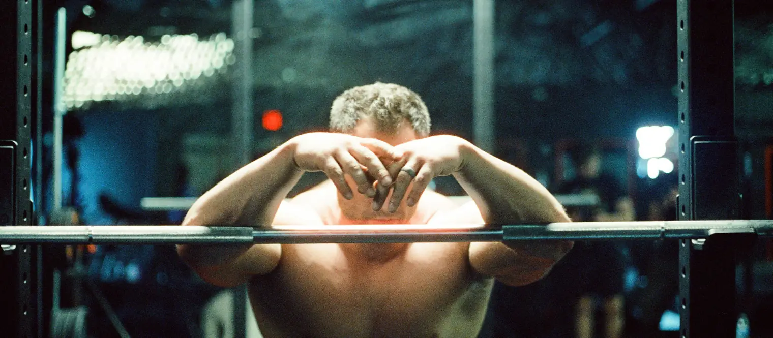 A man holding on to a barbell